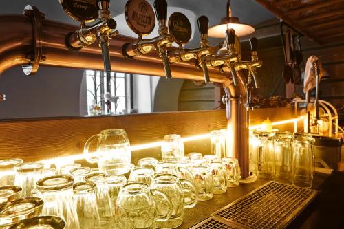 a bunch of glasses are lined up on a counter at Vltavská pohádka in Český Krumlov