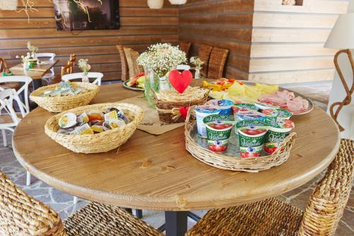 a table with baskets of food and snacks on it at Vltavská pohádka in Český Krumlov