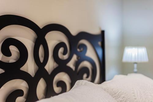 a bed with a black and white headboard and a lamp at Casa Ríos in Biescas