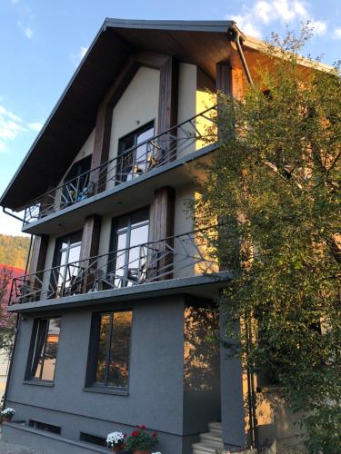 a house with a balcony on the side of it at Girske Povitria 2 in Yaremche