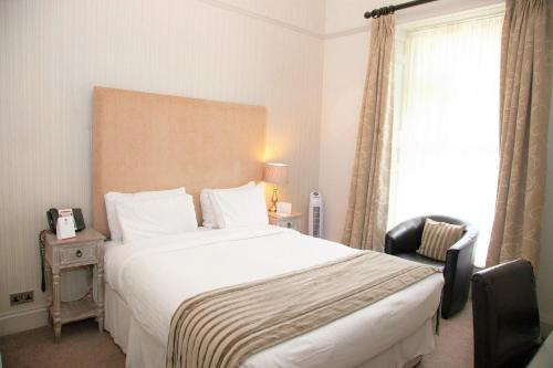 a hotel room with a large bed and a window at Aston Hall Hotel, BW Signature Collection in Sheffield