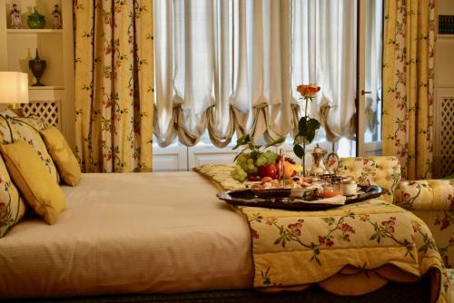 a bedroom with a bed with a tray of food on it at Palazzina Mori - Luxury B&B in San Donà di Piave