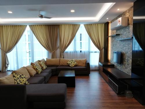 a living room with a couch and a tv at Vivacity jazz suite 3 condo 139 in Kuching