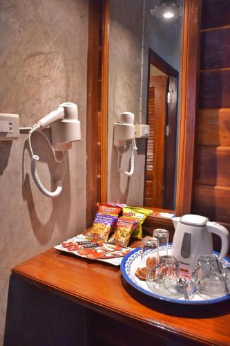 a counter with a telephone and a plate of food at Mango House in Sukhothai