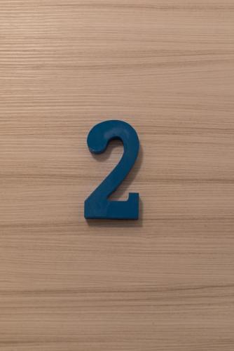 a blue number two on a wooden surface at InGarda Rooms in Cavalcaselle