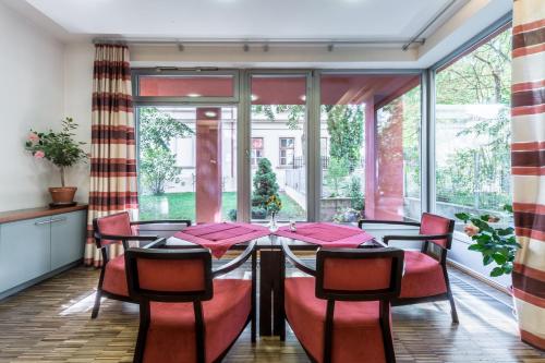 a dining room with a table and chairs at Penzion Palouček in Prague