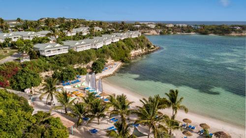 an aerial view of a beach with palm trees and a resort at The Verandah Antigua - All Inclusive - Adults Only in Willikies