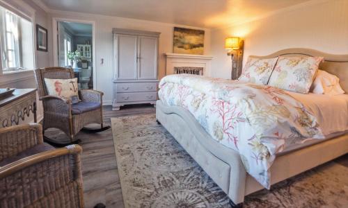 a bedroom with a bed and a table and a chair at Dungeness Barn House Bed and Breakfast at Two Crows Farm in Sequim