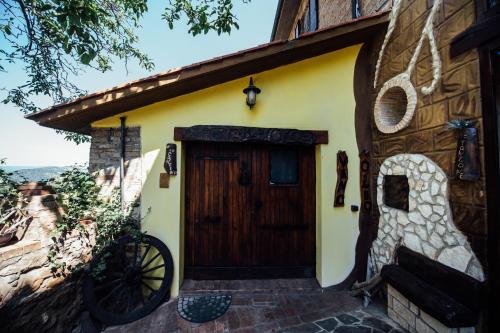 a house with a wooden door with a bicycle parked outside at Agriturismo il Noce in Castiglione dʼOrcia