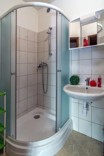 a bathroom with a shower and a sink at Chata Alpina in Ružomberok