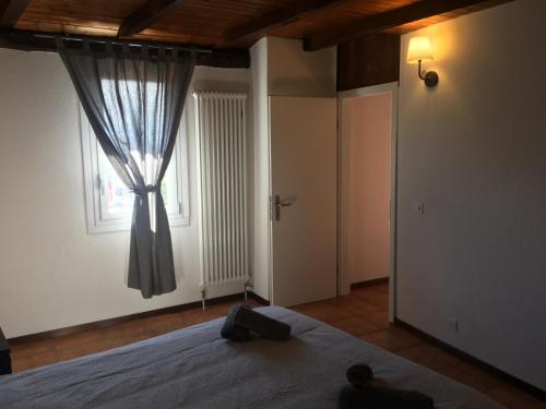 a bedroom with a bed and a window at Albergo Ristorante Belcantone in Novaggio
