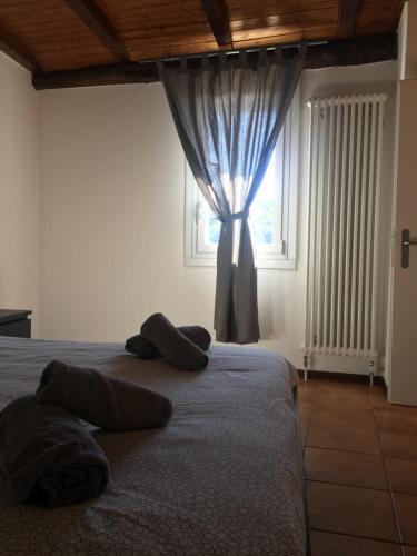 a bedroom with a bed with pillows and a window at Albergo Ristorante Belcantone in Novaggio