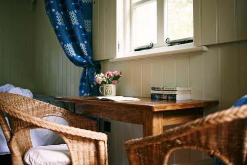 a room with a table and two chairs and a window at The Huts in the Hills in Llanigon
