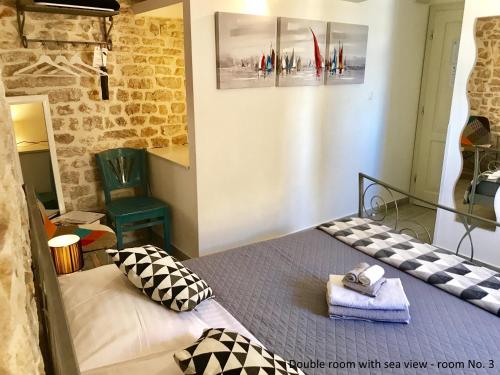 a bedroom with a bed with a towel on it at City Rooms Šibenik in Šibenik