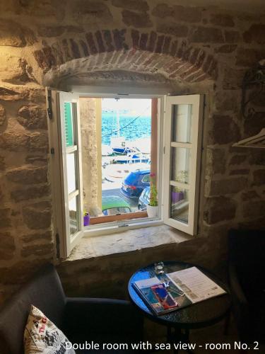 a room with a window with a room with sea view at City Rooms Šibenik in Šibenik