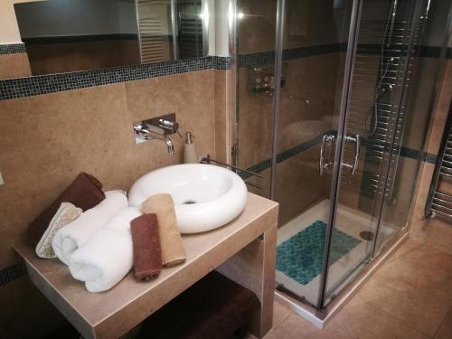 a bathroom with a sink and a shower at La Cartapesta in Lecce