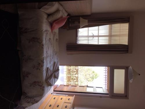 a window in a room with a bed and a windowneau at Holmhurst Guest House in Bathurst