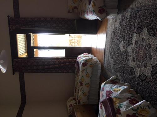 a room with a window and a couch and a curtain at Holmhurst Guest House in Bathurst