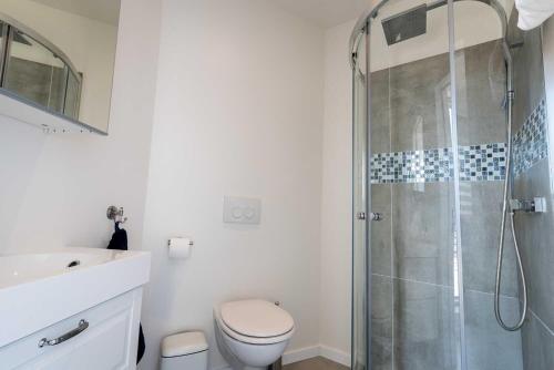 a bathroom with a shower and a toilet and a sink at Apartments Brussels Airport in Zaventem