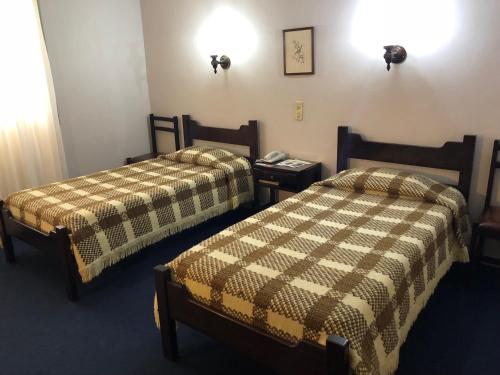 Tempat tidur dalam kamar di Hotel Santa Cruz