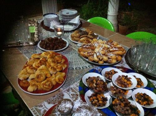a table with many plates of food on it at Ferme D"Hote Lala Fatima in Aïn Leuh