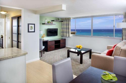 a living room with a view of the ocean at Aqua Skyline at Island Colony in Honolulu