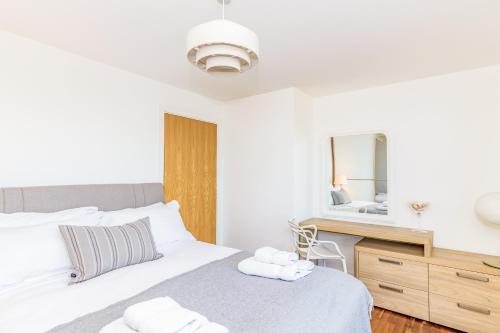 a bedroom with a bed and a mirror at Oxfordshire Living - The Monroe Apartment - Oxford in Oxford