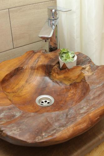 a wooden sink with two plants on top of it at Apartman ŠOKICA in Bizovac