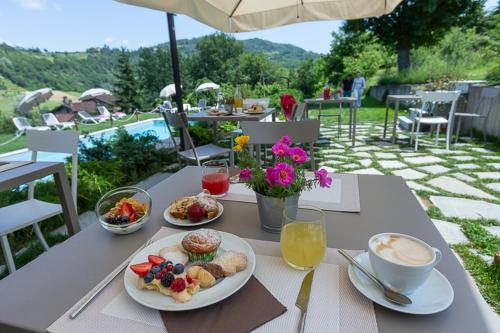 a table with plates of food and drinks on it at Agriturismo Nonna Du in Gavi