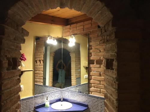 a bathroom with a sink and a mirror at El Mirador in Quinto