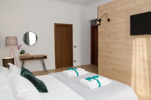 a hotel room with two towels on a bed at Panoramica dei Templi B&B in Agrigento