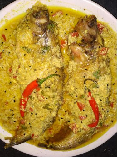a white plate of food with meat and peppers at Royal Paying Guest in Kolkata
