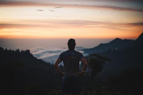a man standing on top of a mountain looking at the sunset at Masaya Casas Viejas in Minca