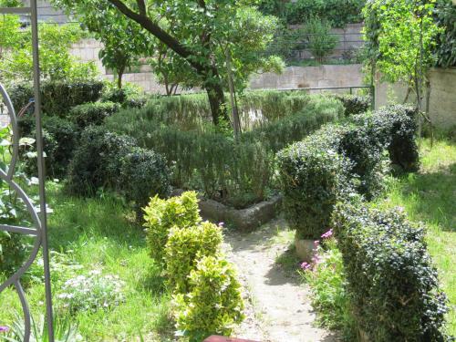 a garden with bushes and a walkway at Guesthouse Vrlic in Split