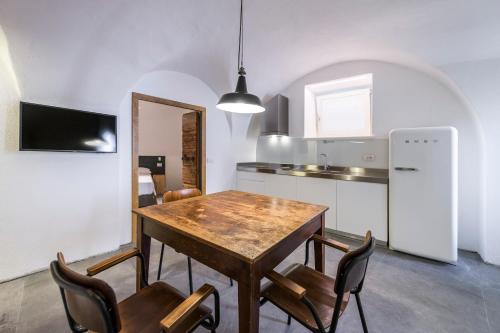 a kitchen with a wooden table and chairs at Casa Kaki in Malcesine