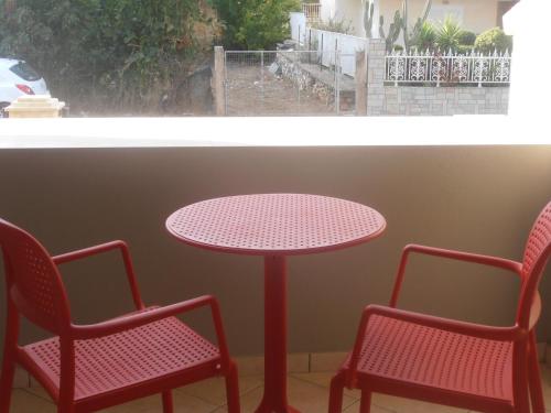 a table and two chairs and a table and a window at Melia in Aliveri