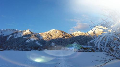 a view of a snow covered mountain range with a lake at Haus Sonnblick in Wangle