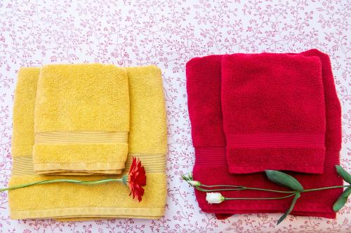 two towels sitting next to each other on a table at L'Enchantraine - gîte tout confort et tarif tout inclus - appartement spacieux et accueillant sur Epinal in Épinal