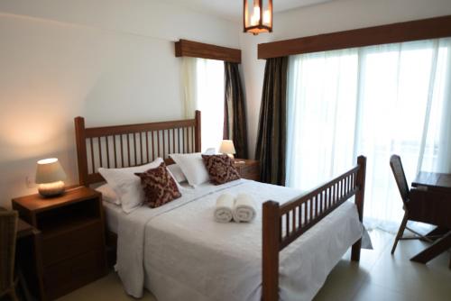 En eller flere senge i et værelse på Pipa Residence