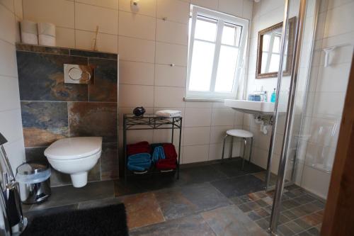 a bathroom with a toilet and a sink at LACHGUT in Thalling