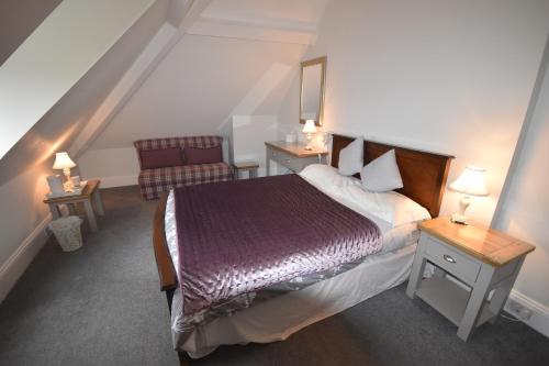 a hotel room with a bed and a chair at Gordon House in Wimborne Minster