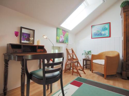 a living room with a desk and a chair at FEWO 16, Herrenhaus Blengow, Lindenallee 21 in Rerik