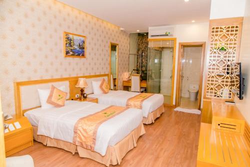 Ένα ή περισσότερα κρεβάτια σε δωμάτιο στο Palm Hotel Thanh Hoa