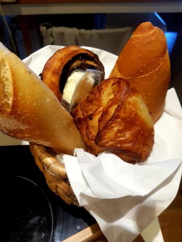 a basket filled with different types of pastries on a table at Neot Golf, Ziv's Place in Caesarea