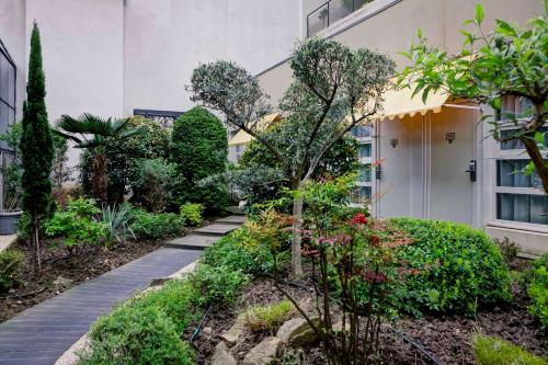 a garden path in front of a house at Best Western Crequi Lyon Part Dieu in Lyon