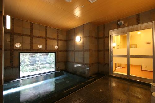 een lege kamer met een zwembad in het midden van een kamer bij Hotel Route-Inn Yaizu Inter in Yaizu