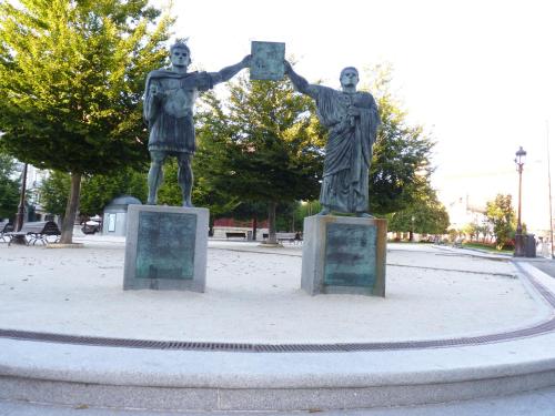 a statue of two men holding up a cube at Hotel España in Lugo