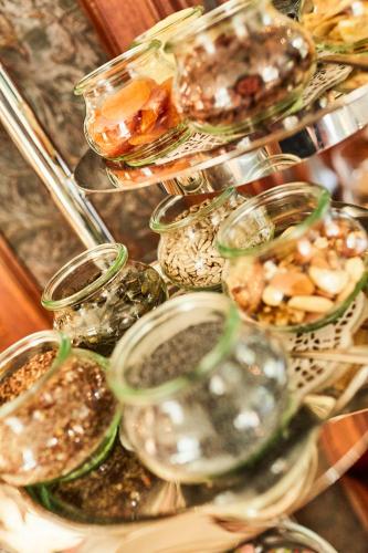 a bunch of glass jars with different types of food at Hotel Cap Polonio in Pinneberg
