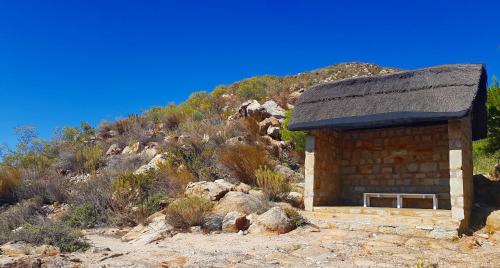 a small building with a roof on a mountain at Montagu Little Sanctuary - Hot Spring Access at Special Rate in Montagu