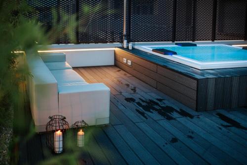 a jacuzzi tub sitting on top of a deck at JO Hotel in Marano Lagunare